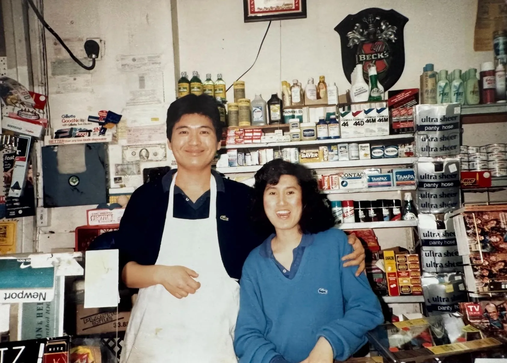 Man and woman behind grocery store counter