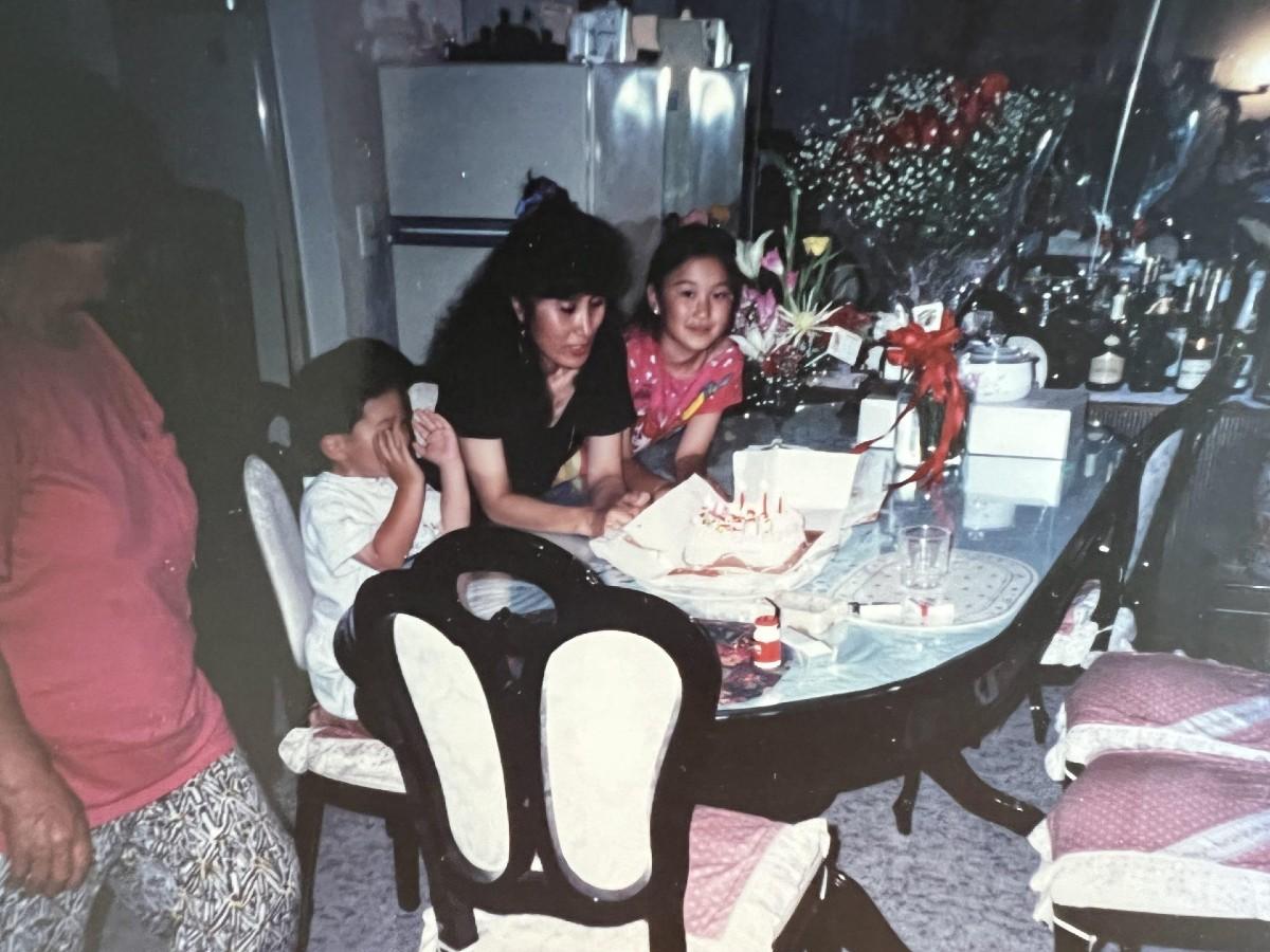 A personal photo shared by withco founder, Kevin Song. Pictured is a family sitting around a dining room table.